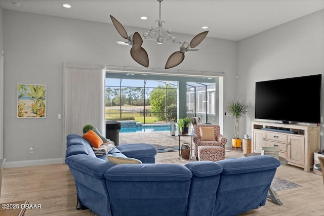 living room featuring light hardwood / wood-style floors and ceiling fan