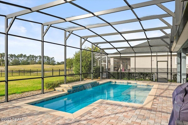 view of swimming pool with glass enclosure, pool water feature, a lawn, and a patio