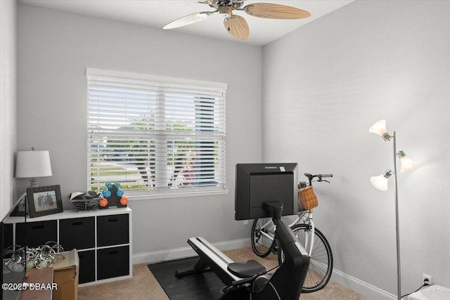 workout area featuring light carpet and ceiling fan