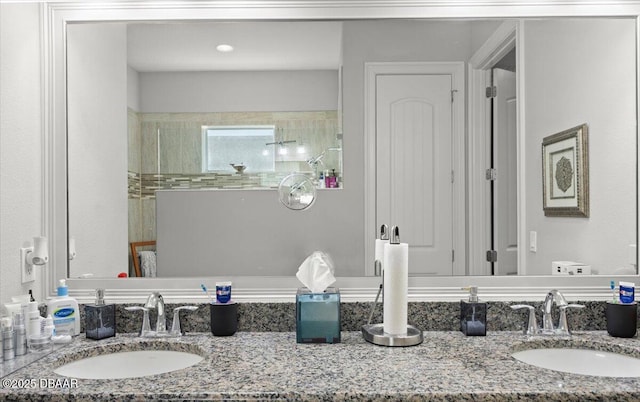 bathroom with vanity and a shower