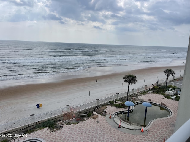 water view featuring a view of the beach and fence