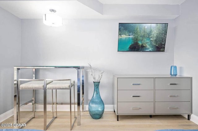 bedroom featuring baseboards and wood finished floors