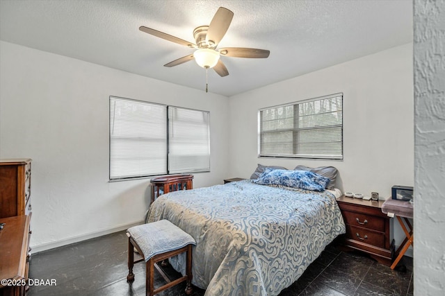 bedroom with a textured ceiling and ceiling fan