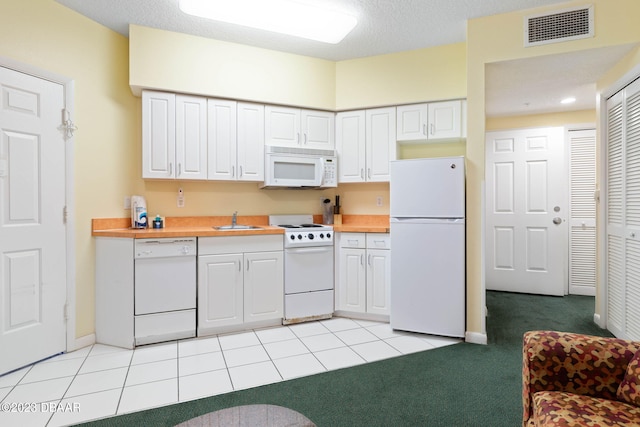 kitchen with white cabinets, a textured ceiling, light carpet, sink, and white appliances