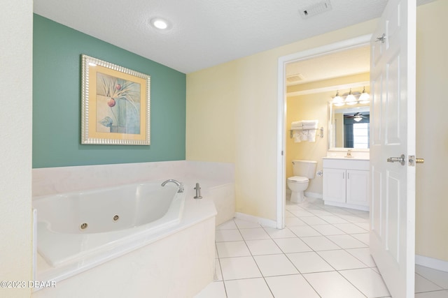 bathroom featuring a washtub, vanity, a textured ceiling, and toilet