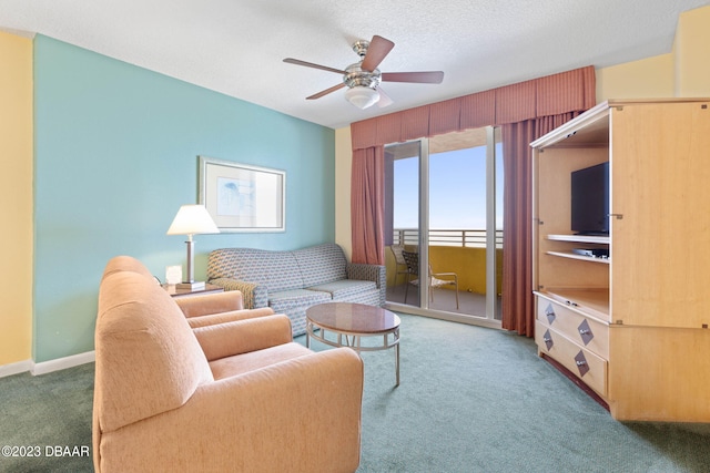 carpeted living room with a textured ceiling and ceiling fan