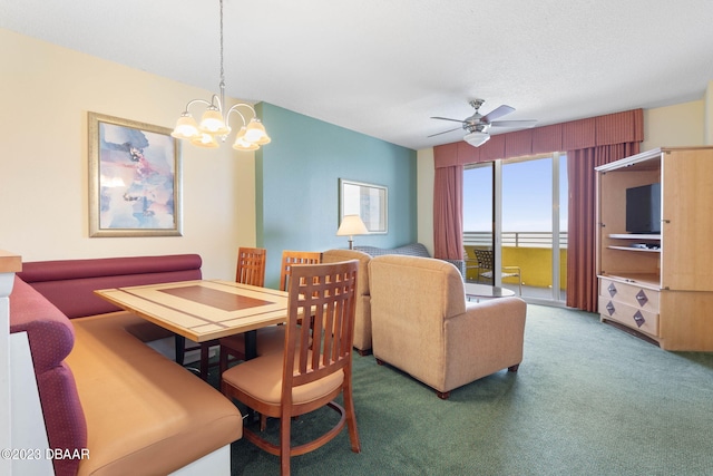 dining space featuring ceiling fan with notable chandelier and carpet flooring