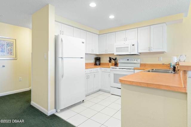 kitchen featuring white cabinetry, sink, kitchen peninsula, white appliances, and light colored carpet