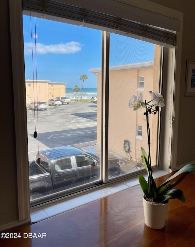 interior space with a beach view and a water view