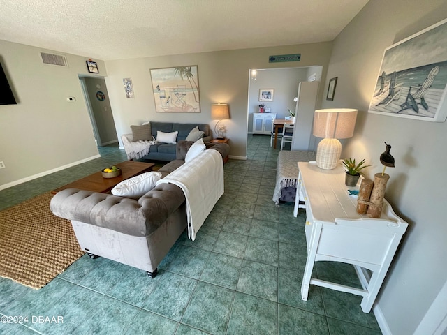 tiled living room featuring a textured ceiling