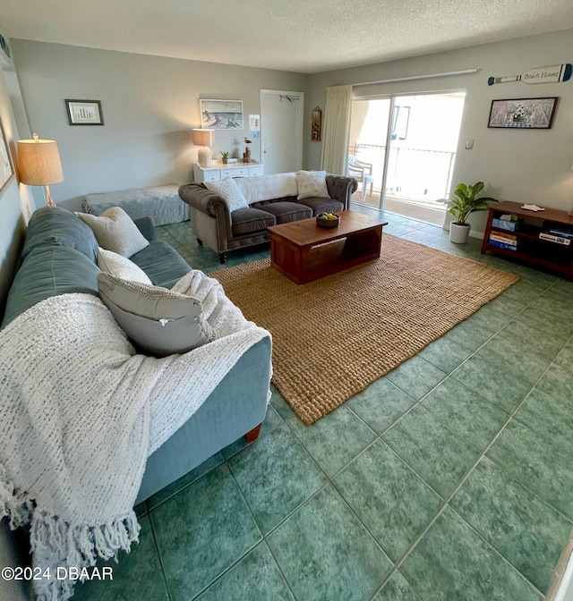 living room with a textured ceiling and tile patterned floors