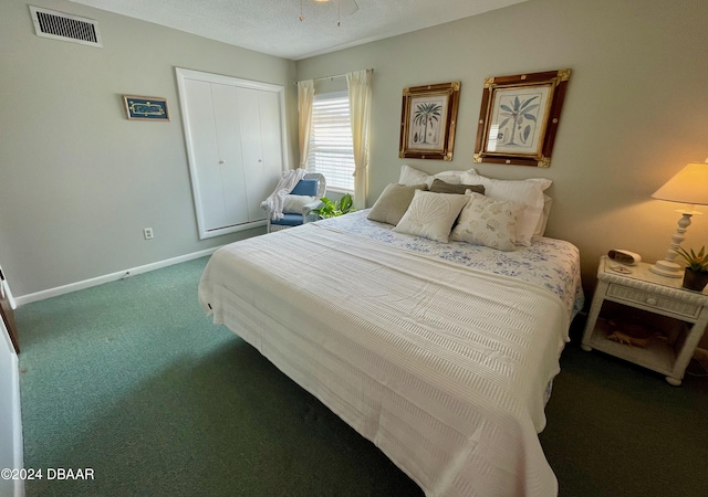 bedroom with carpet flooring, a textured ceiling, and a closet