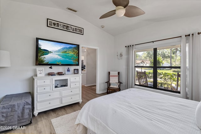 bedroom featuring visible vents, wood finished floors, ceiling fan, and vaulted ceiling