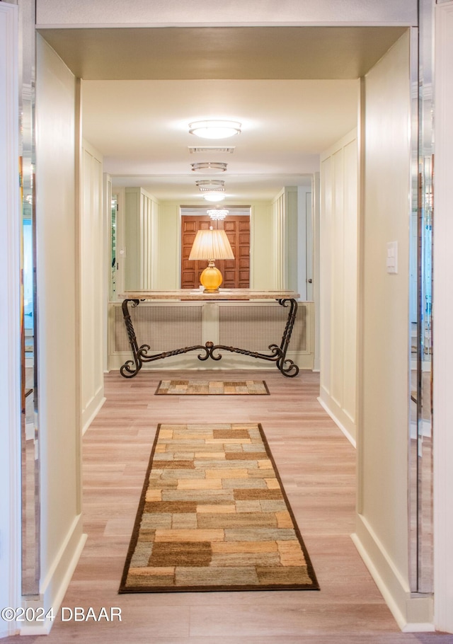 corridor with light wood-type flooring