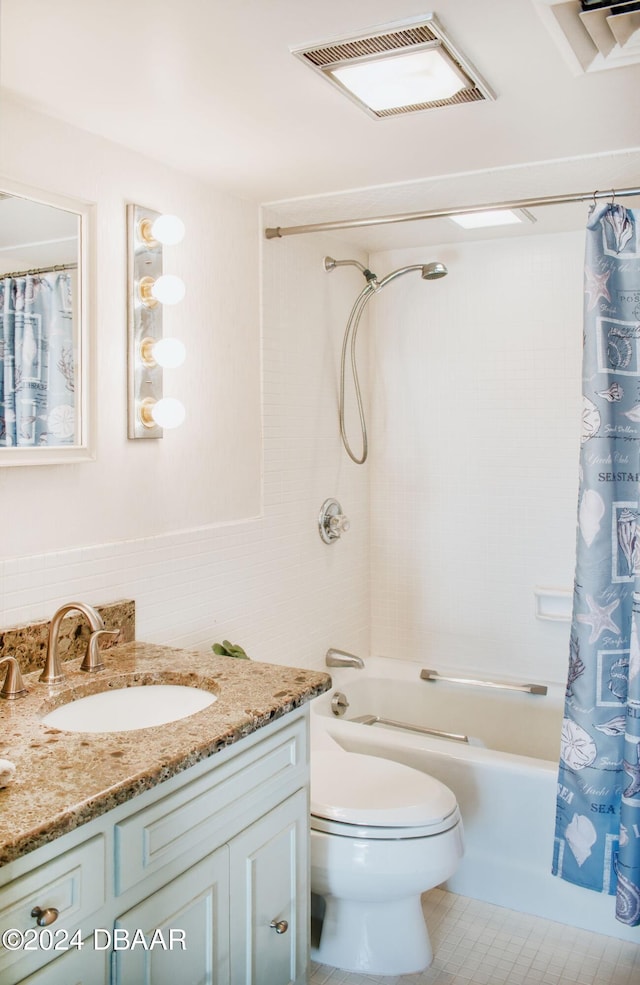 full bathroom with toilet, vanity, and shower / tub combo with curtain