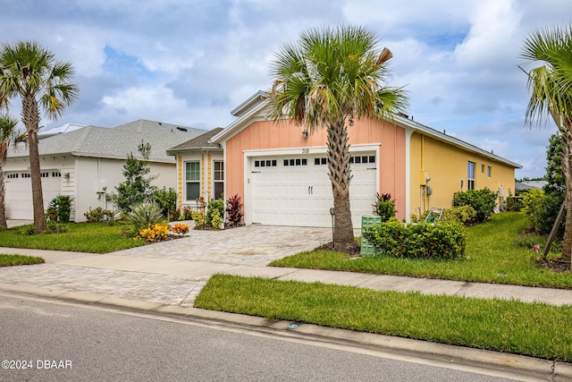 ranch-style house with a garage and a front yard