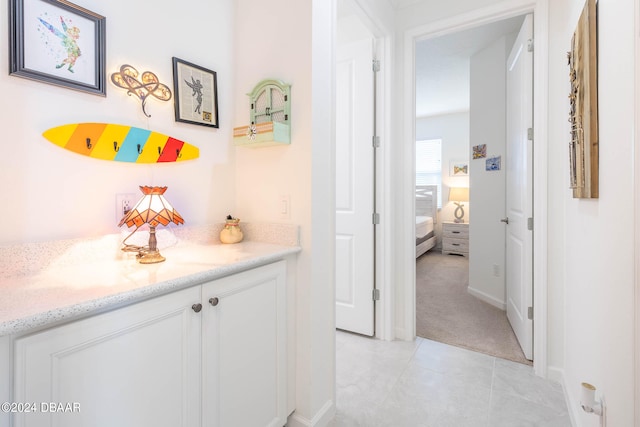 corridor featuring light tile patterned floors