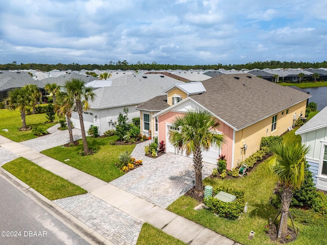 318 Good Life Way, Daytona Beach, FL 32124 - view of front facade featuring decorative driveway, an attached garage, a residential view, and stucco siding