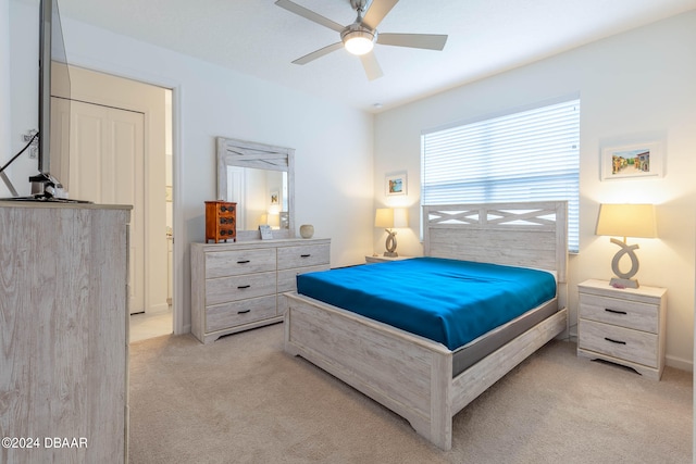 bedroom with light carpet and ceiling fan