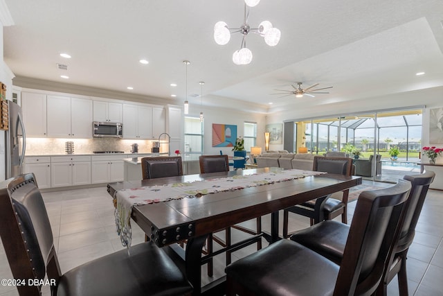 dining area with ceiling fan, light tile patterned floors, and crown molding