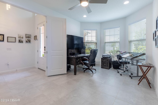 home office featuring a wealth of natural light, ceiling fan, and light tile patterned floors