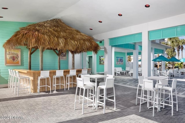 view of patio with an outdoor bar and a gazebo