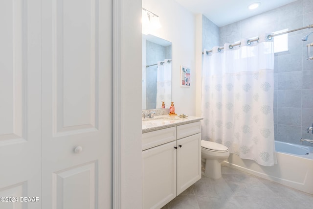 full bathroom featuring toilet, vanity, shower / bath combo with shower curtain, and tile patterned flooring