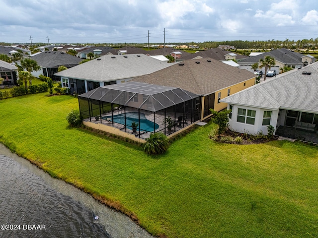 view of swimming pool with a lanai and a yard