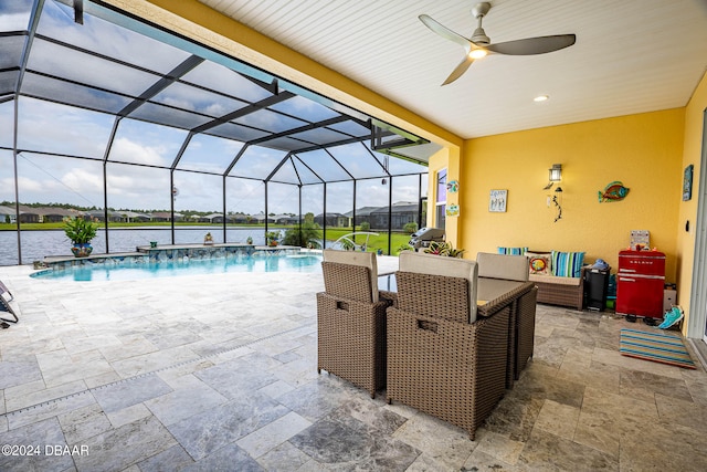 view of swimming pool featuring a water view, ceiling fan, a patio, a lanai, and pool water feature