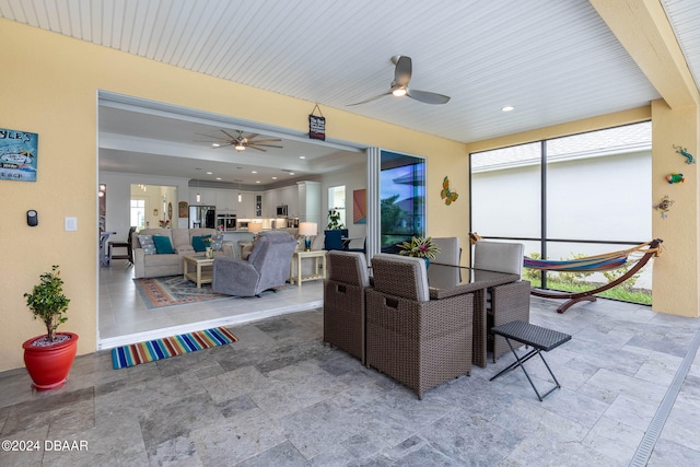 dining space with wooden ceiling, a wealth of natural light, and ceiling fan