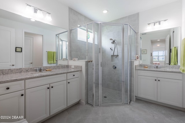 bathroom featuring walk in shower and vanity