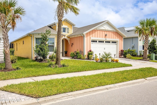 view of front of property with a garage and a front lawn