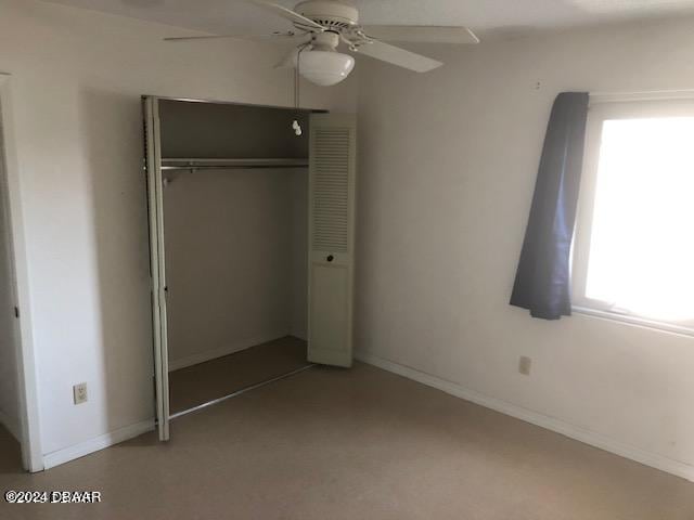 unfurnished bedroom featuring a closet and ceiling fan