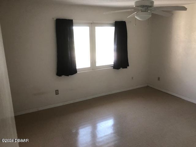 spare room with ceiling fan