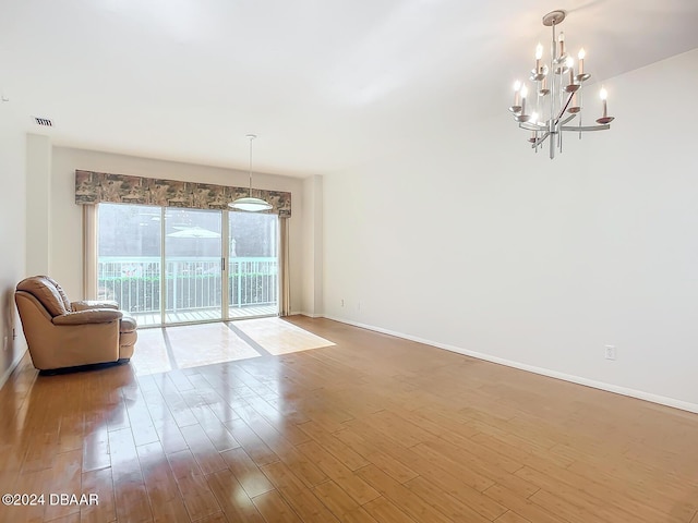 4 Oceans W Blvd Unit 108B, Daytona Beach Shores, FL 32118 - living room with a chandelier, baseboards, and wood finished floors