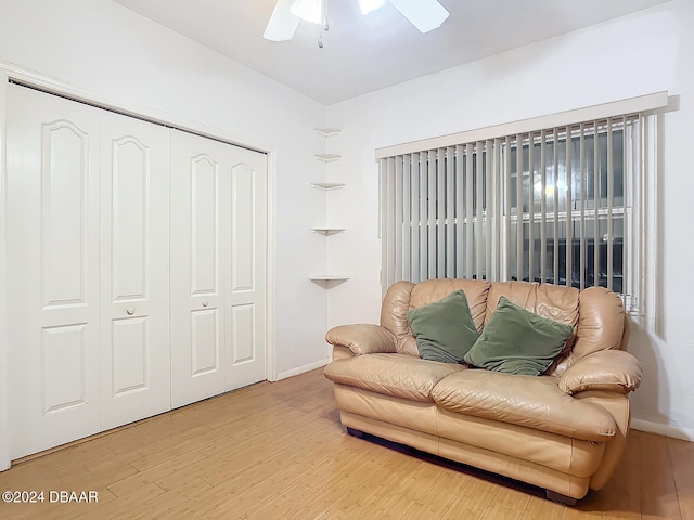 sitting room with hardwood / wood-style floors and ceiling fan