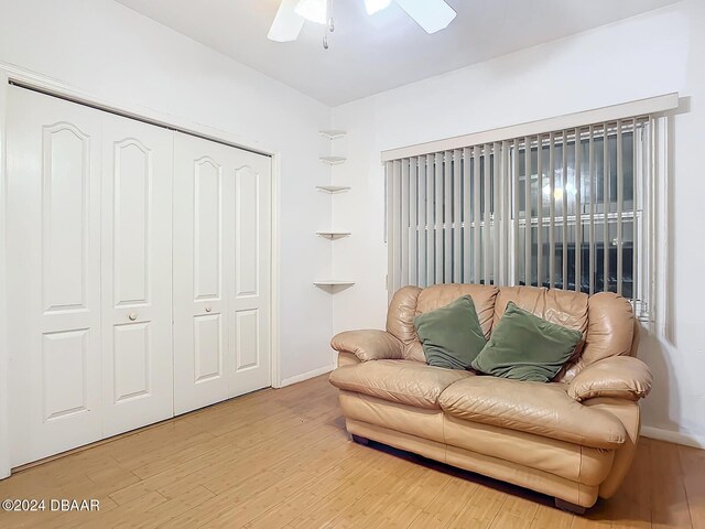 4 Oceans W Blvd Unit 108B, Daytona Beach Shores, FL 32118 - living area with a ceiling fan, wood finished floors, and baseboards
