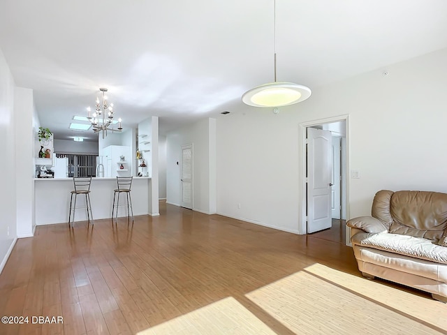 4 Oceans W Blvd Unit 108B, Daytona Beach Shores, FL 32118 - living room featuring a chandelier, wood finished floors, and baseboards