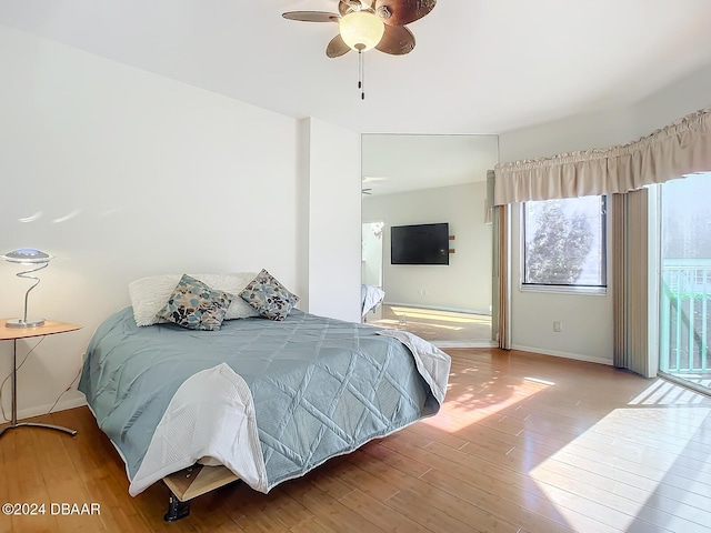 4 Oceans W Blvd Unit 108B, Daytona Beach Shores, FL 32118 - bedroom featuring wood finished floors, ceiling fan, baseboards, and access to exterior