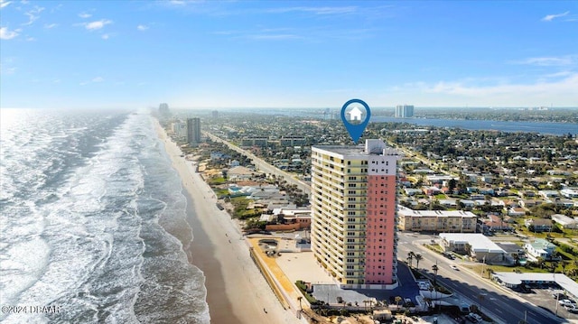 birds eye view of property featuring a view of city, a beach view, and a water view