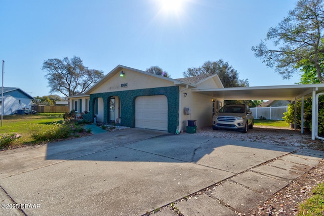 view of front of home featuring a garage, concrete driveway, fence, a carport, and stucco siding