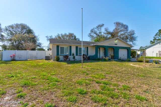 ranch-style home featuring central AC unit, a garage, fence, stucco siding, and a front lawn