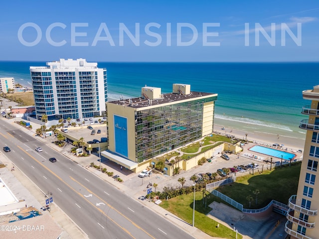 drone / aerial view featuring a water view and a beach view