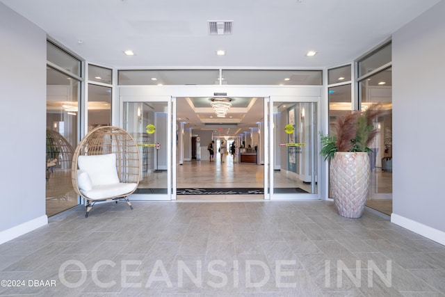 foyer featuring visible vents, recessed lighting, baseboards, and expansive windows