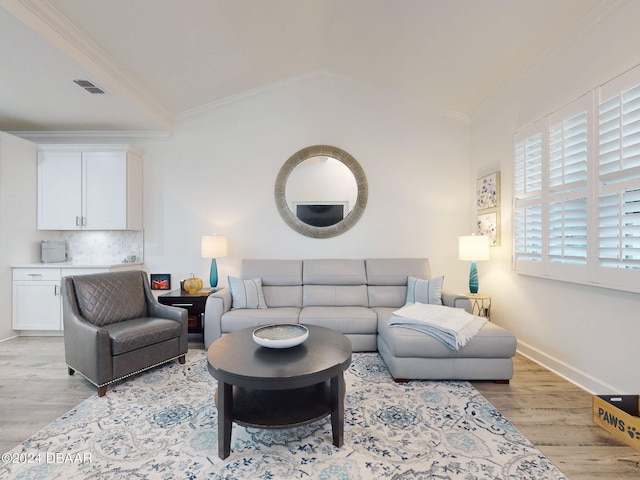 452 Lime Ave, Daytona Beach, FL 32124 - living room featuring light wood-type flooring, ornamental molding, visible vents, and vaulted ceiling