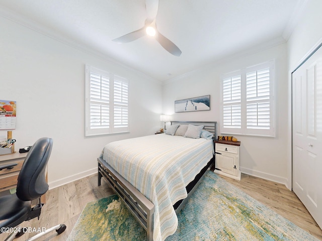 452 Lime Ave, Daytona Beach, FL 32124 - bedroom featuring crown molding, baseboards, a ceiling fan, and light wood-style flooring
