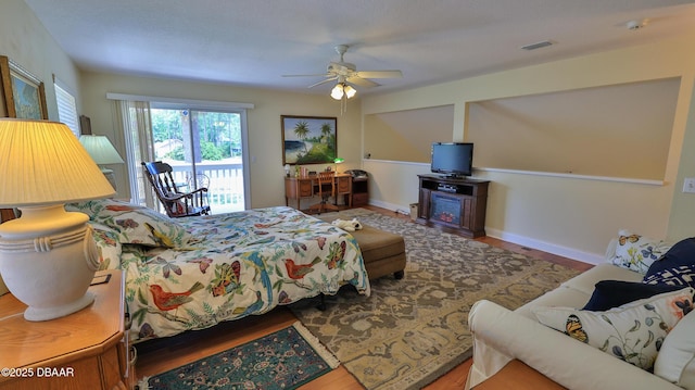 bedroom with access to outside, ceiling fan, and hardwood / wood-style flooring