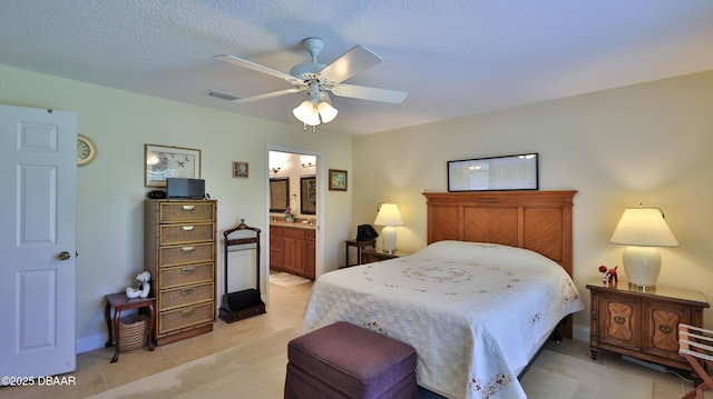 bedroom featuring ceiling fan, connected bathroom, and a textured ceiling