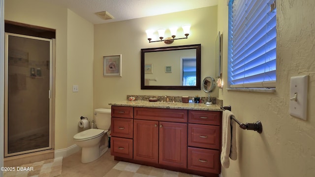 bathroom with a textured ceiling, tile patterned floors, vanity, toilet, and a shower with shower door