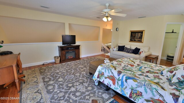 bedroom with ceiling fan and dark hardwood / wood-style floors